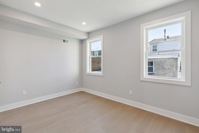 unfurnished room with light hardwood / wood-style floors