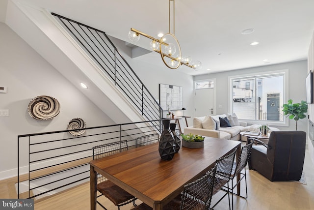 dining room with a notable chandelier and light hardwood / wood-style floors