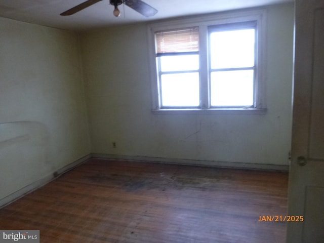 spare room with wood-type flooring and ceiling fan