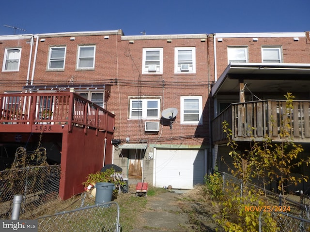 rear view of property with a garage