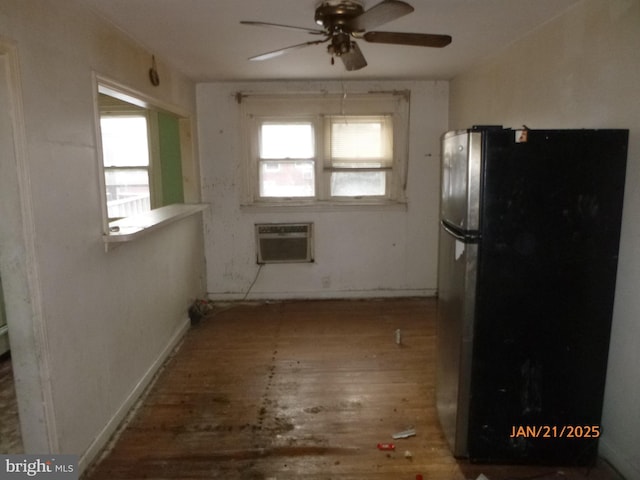 kitchen featuring hardwood / wood-style flooring, ceiling fan, a wall mounted AC, and stainless steel refrigerator