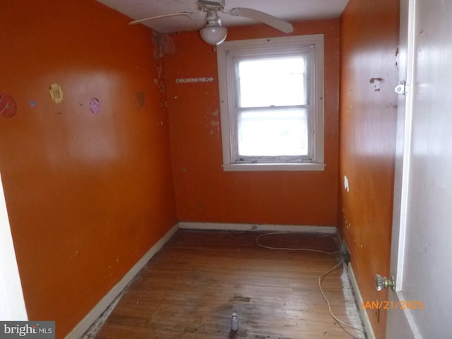 empty room featuring hardwood / wood-style flooring and ceiling fan