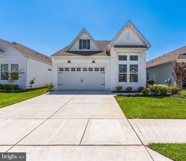 view of front of home with a garage and a front lawn