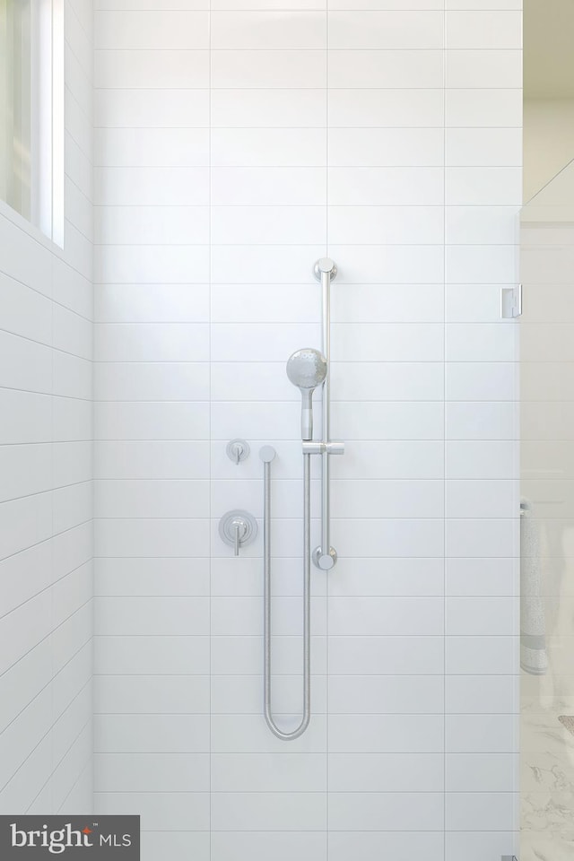 bathroom with tiled shower