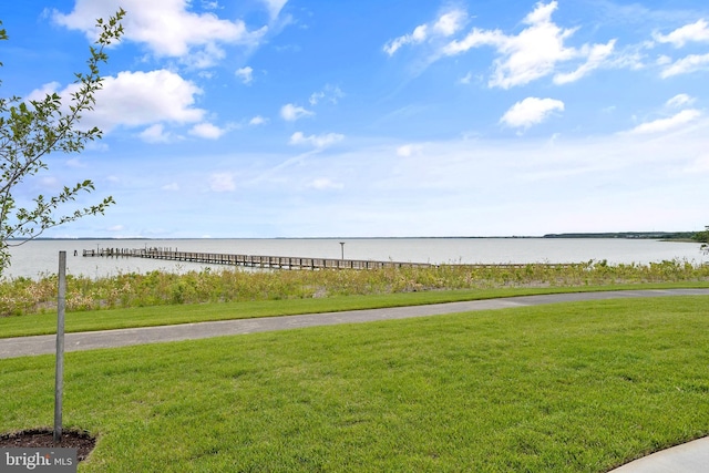 view of community featuring a water view and a lawn