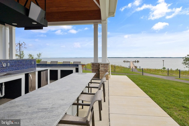 view of patio / terrace featuring a water view and a bar