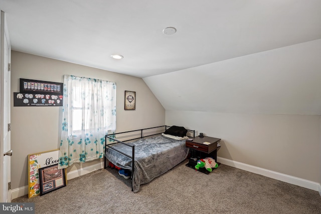 carpeted bedroom with vaulted ceiling