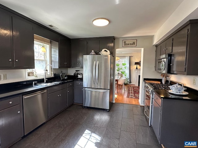 kitchen featuring appliances with stainless steel finishes, sink, and a wealth of natural light