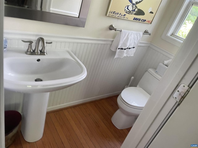 bathroom with hardwood / wood-style flooring, sink, and toilet