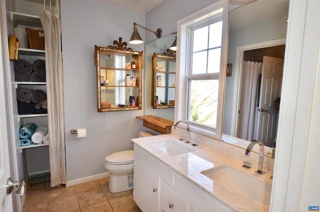 bathroom featuring vanity, tile patterned floors, and toilet