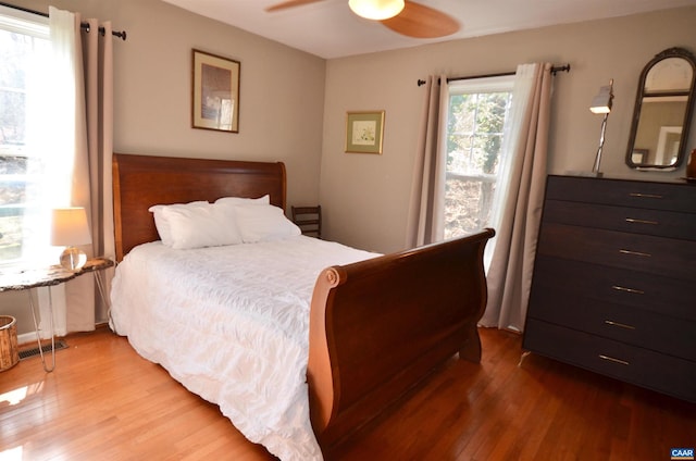 bedroom with wood-type flooring and ceiling fan