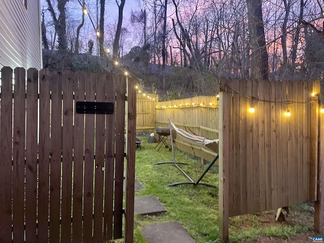 gate at dusk with a lawn