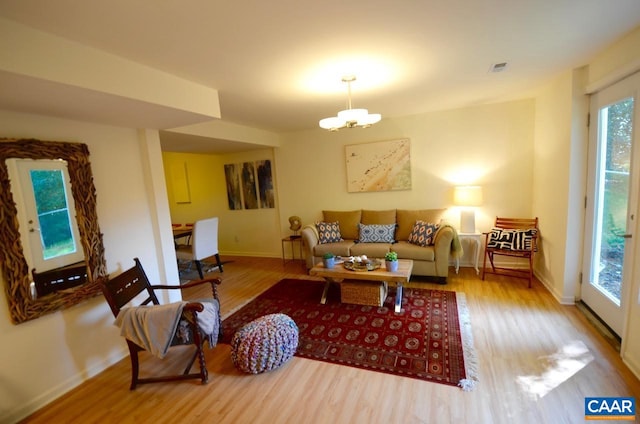 living room featuring hardwood / wood-style floors and an inviting chandelier