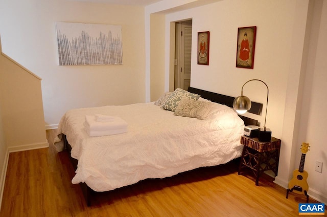 bedroom with hardwood / wood-style flooring