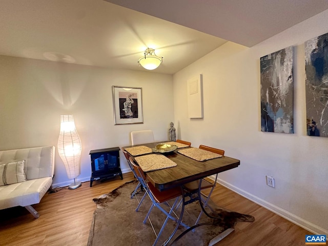 dining space with hardwood / wood-style flooring