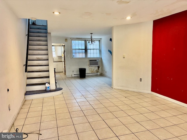 interior space featuring a wall mounted air conditioner, light tile patterned floors, an inviting chandelier, and baseboard heating