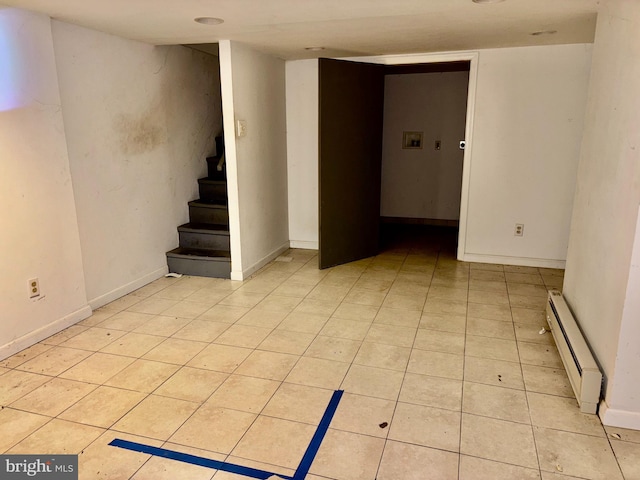 tiled spare room with baseboard heating