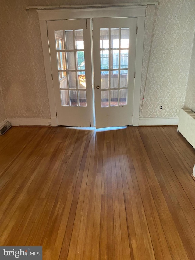 interior space with radiator and wood-type flooring