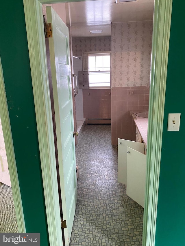 bathroom with tile walls and a baseboard radiator