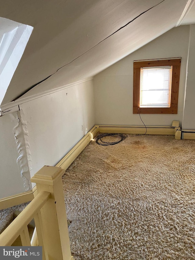 bonus room with baseboard heating, carpet floors, and vaulted ceiling