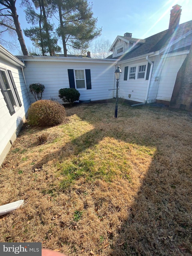 view of property exterior with a yard