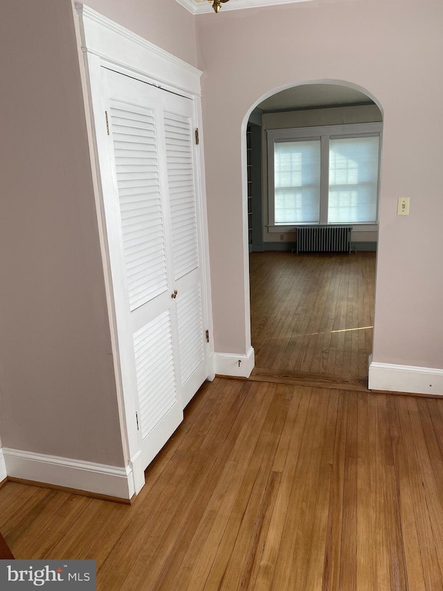 hallway featuring radiator and hardwood / wood-style floors