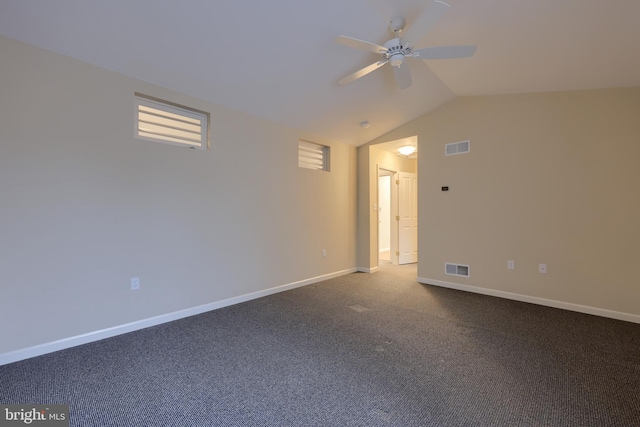 unfurnished room featuring ceiling fan, vaulted ceiling, and carpet