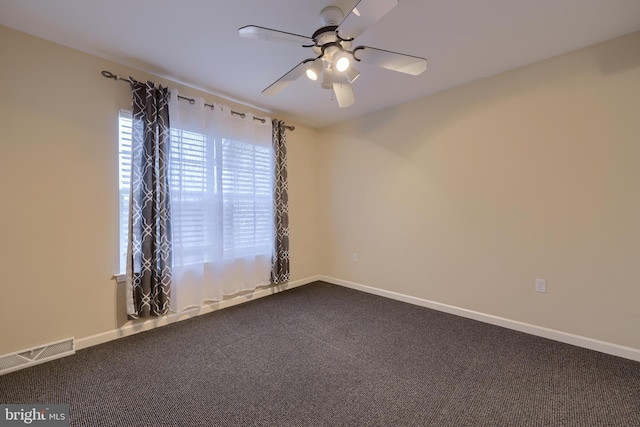 carpeted spare room with ceiling fan