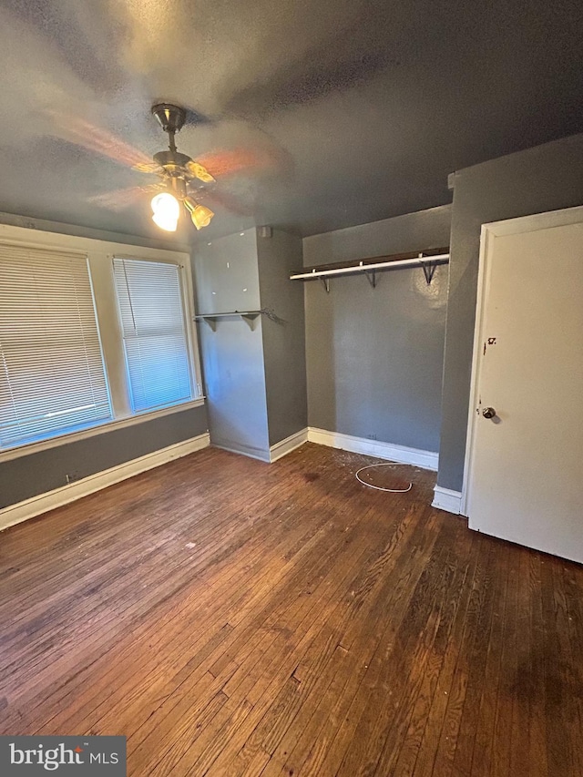 unfurnished bedroom with hardwood / wood-style flooring, ceiling fan, a textured ceiling, and a closet