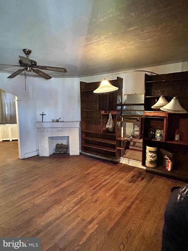 living room with hardwood / wood-style flooring, a fireplace, and ceiling fan