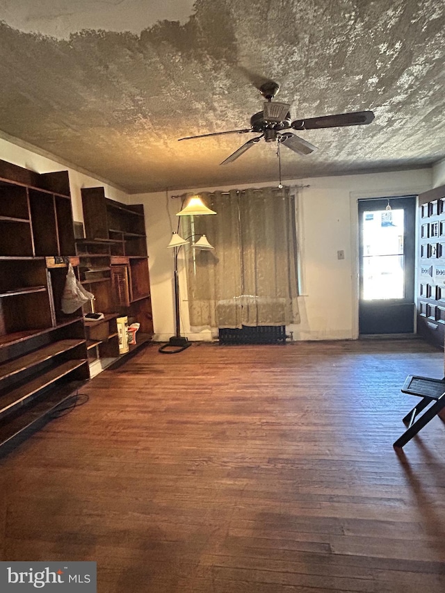 interior space with ceiling fan and hardwood / wood-style floors