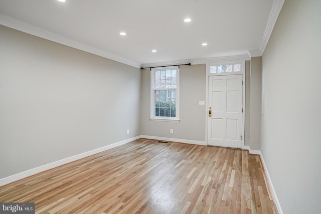 entryway with crown molding and light hardwood / wood-style flooring