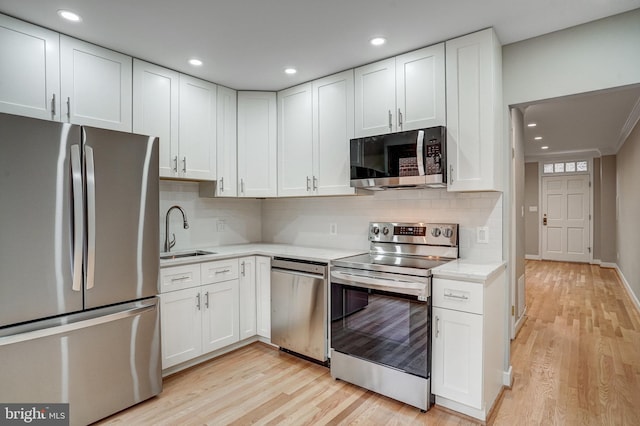 kitchen with white cabinetry, appliances with stainless steel finishes, and sink