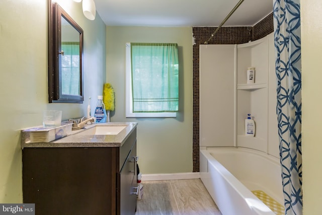 bathroom with vanity, shower / tub combo, a wealth of natural light, and wood-type flooring