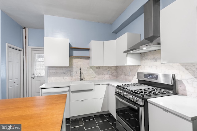 kitchen with white cabinetry, sink, stainless steel range with gas stovetop, and wall chimney exhaust hood