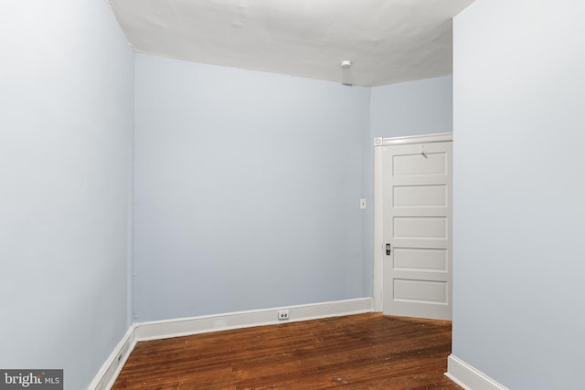 empty room with dark hardwood / wood-style floors