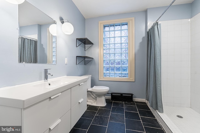 bathroom with vanity, curtained shower, tile patterned floors, and toilet