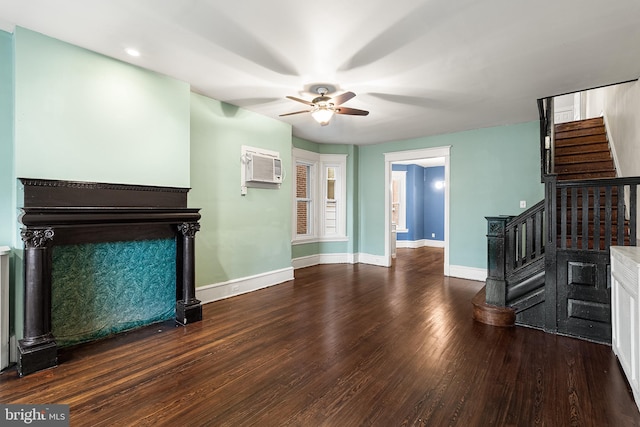 unfurnished living room featuring ceiling fan, a wall mounted AC, and dark hardwood / wood-style flooring