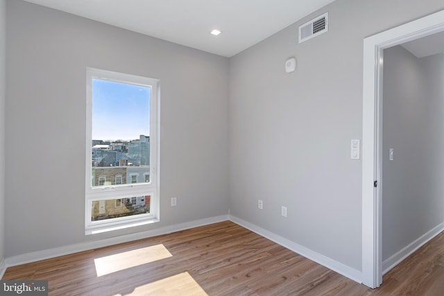 empty room with hardwood / wood-style floors