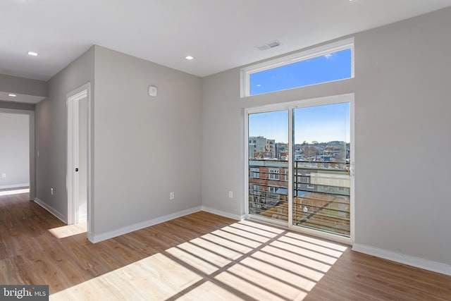 empty room with hardwood / wood-style flooring