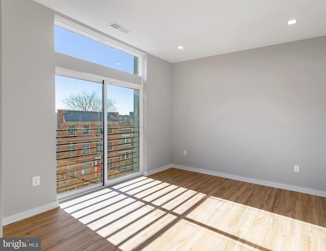 unfurnished room with wood-type flooring