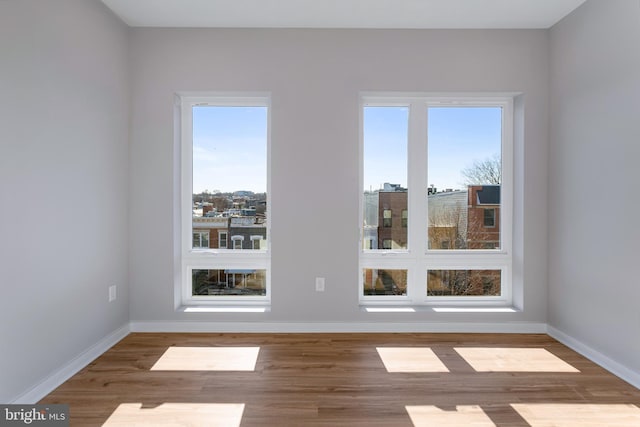 spare room with hardwood / wood-style floors