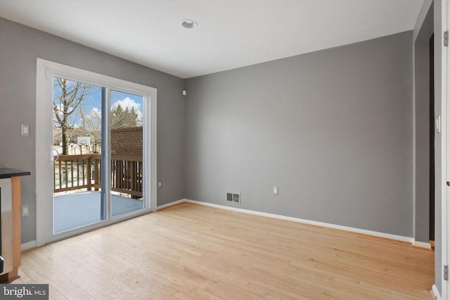 empty room with light hardwood / wood-style floors