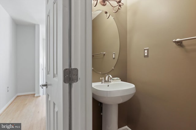 bathroom featuring wood-type flooring and sink