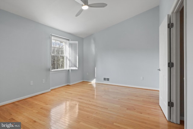 unfurnished bedroom with vaulted ceiling, ceiling fan, and light wood-type flooring