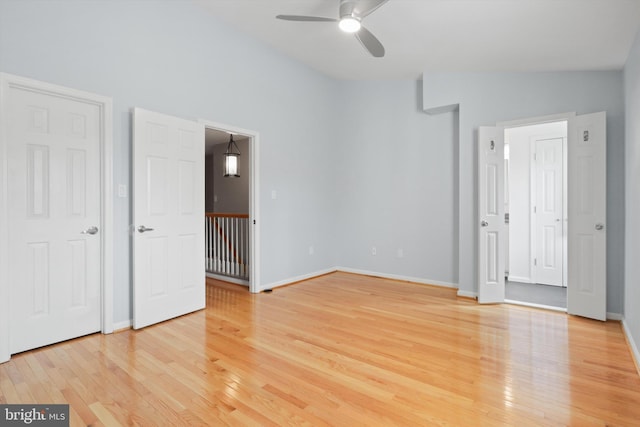 unfurnished bedroom featuring wood-type flooring, lofted ceiling, and ceiling fan