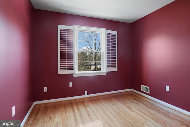 spare room featuring light hardwood / wood-style floors