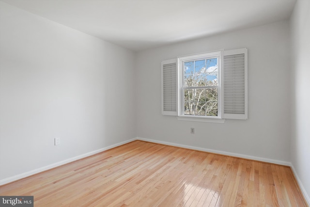 empty room with light hardwood / wood-style flooring