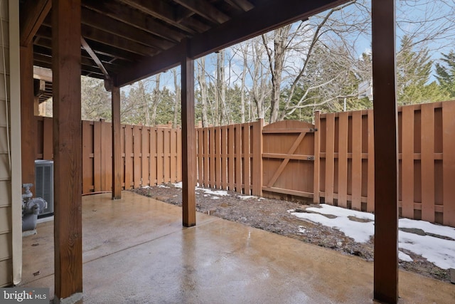 snow covered patio featuring cooling unit