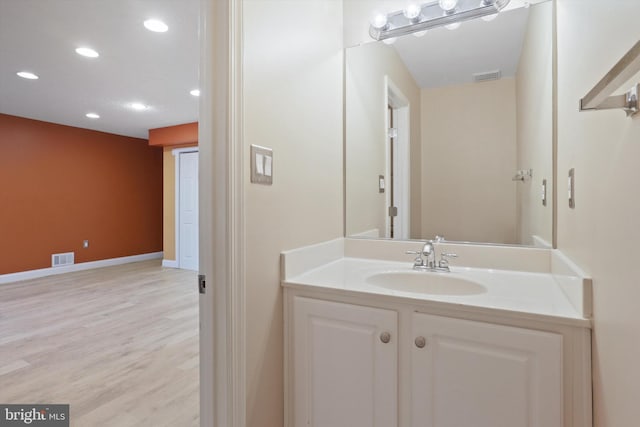 bathroom with vanity and hardwood / wood-style floors